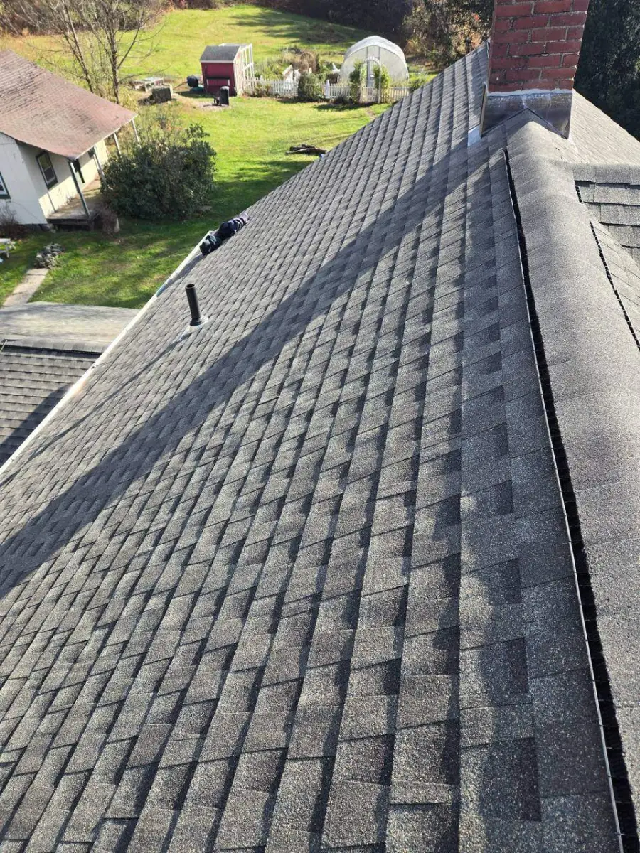 Finished gray dimensional shingle roof on a tidy suburban home