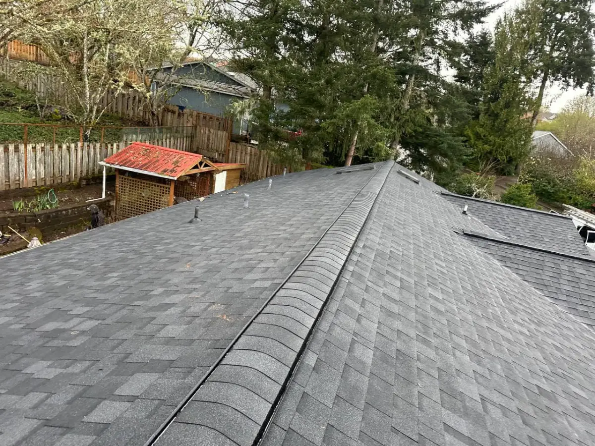 Finished ridge cap line running the length of a shingle roof